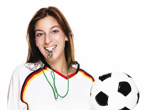 beautiful woman with a whistle holding football on white background