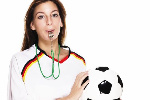 beautiful woman with a whistle wearing football shirt holding football on white background