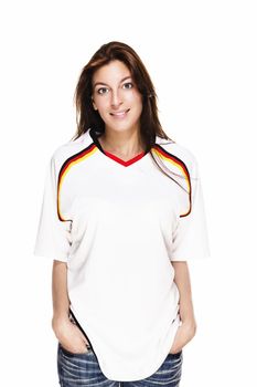 smiling woman wearing football shirt with hands in her pockets on white background