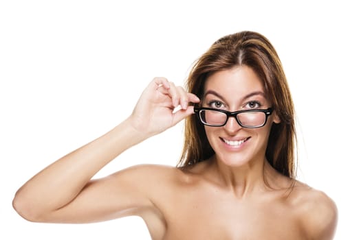 young beautiful woman holding the frame of her glasses on white background