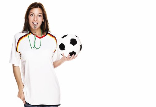 beautiful woman with a whistle wearing football shirt and holding football on white background