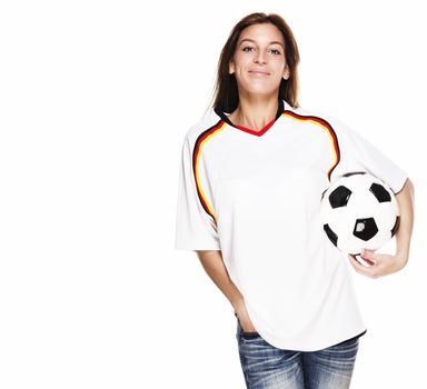 smiling woman wearing football shirt with football under her arm on white background