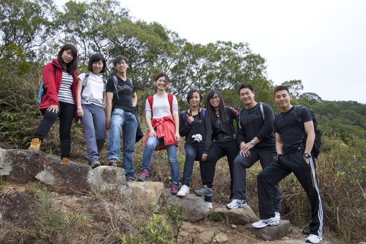 Asian hiking teams in mountains