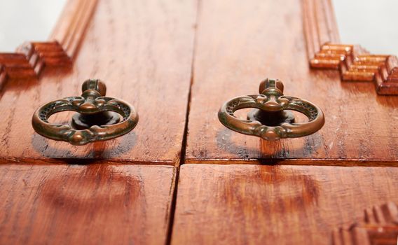 Old furniture hardware on wooden background close up