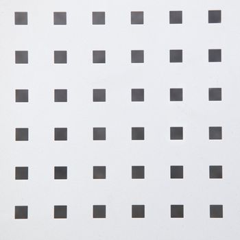 Photograph of a texture with group of small grey-black square shaped boxes.