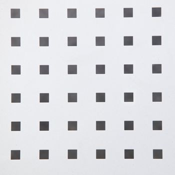 Photograph of a texture with group of small grey-black square shaped boxes.