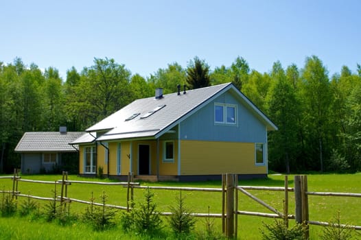 The wooden house on a background of trees