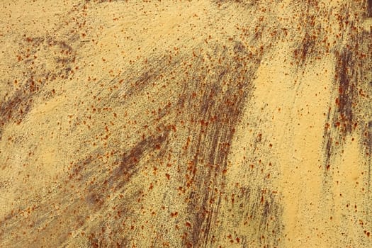 Rusty metal sheet is painted in light brown