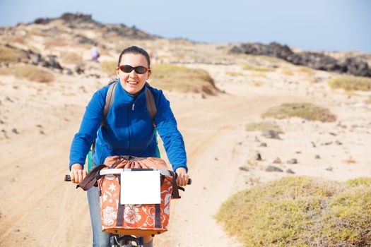 Young woman having a weekend excursion on the bike on a summer day