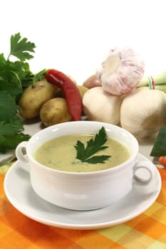 a cup of vegetable creme soup with parsley