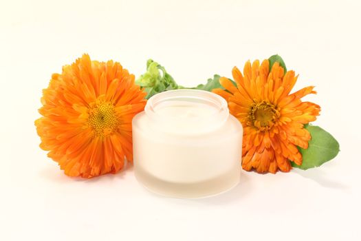 fresh marigold salve with Calendula flowers and leaves on a bright background