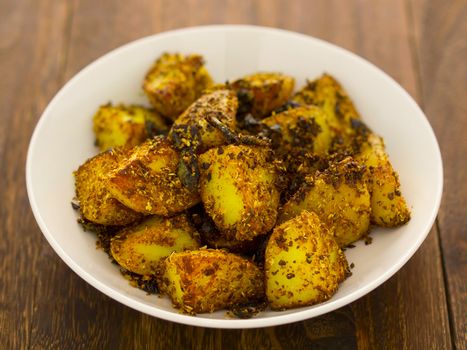 close up of a bowl of crusty baked potatoes