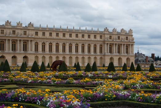 garden of a historic building French, lush flowers