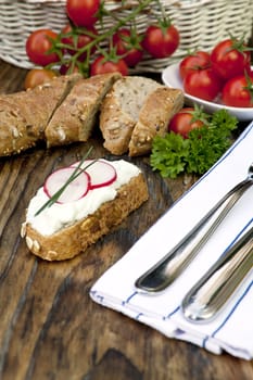 fresh bread with herb curd dinner on wooden background