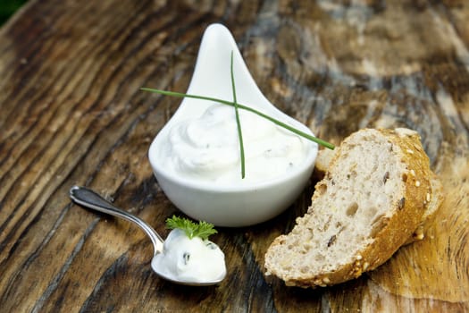 fresh bread with herb curd dinner on wooden background