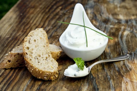 fresh bread with herb curd dinner on wooden background