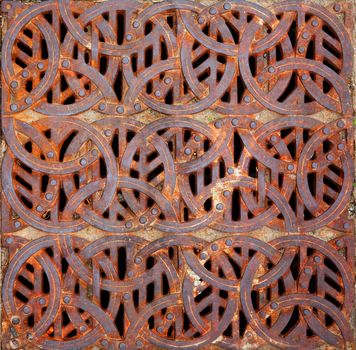 Rusty iron Celtic design storm Grating