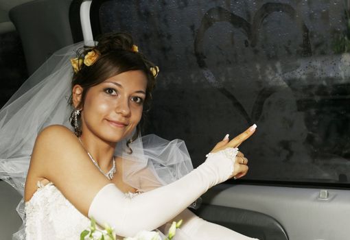 The happy bride in interior of the automobile
