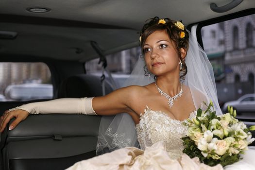 Portrait of beautiful happy bride in car