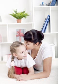 Portrait of happy family lying together, hugging and happy