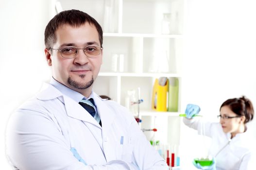 Portrait of the doctor, on a back background work colleagues in a medical office