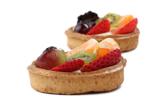 Close-up image of two tasty fruitcakes against a white background.