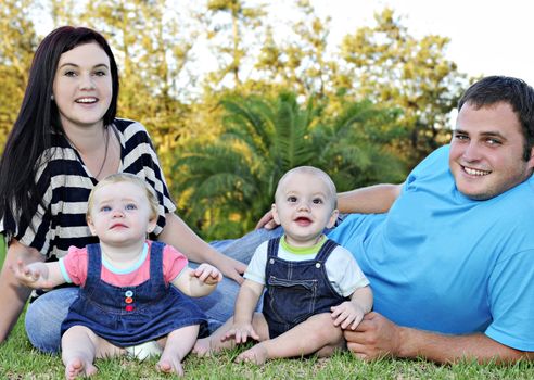 Beautiful young family with twin babies