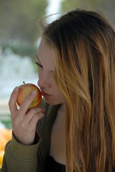 young teen in a market in montpellier for buy red apple
