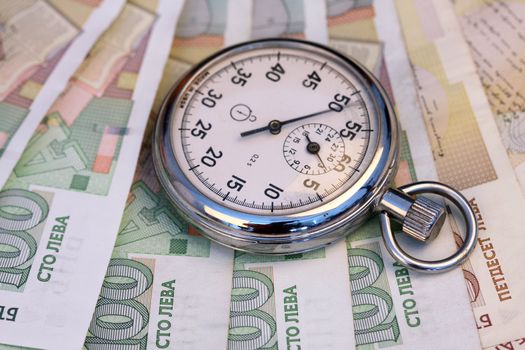 Chronometer and Bulgarian leva  bills, close up , shallow dof