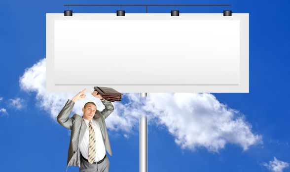 The scared businessman against a publicity board and the bright blue cloudy sky