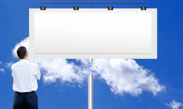 The  businessman against a publicity board and the bright blue cloudy sky