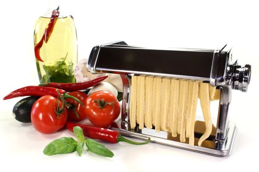 a pasta machine with homemade noodles