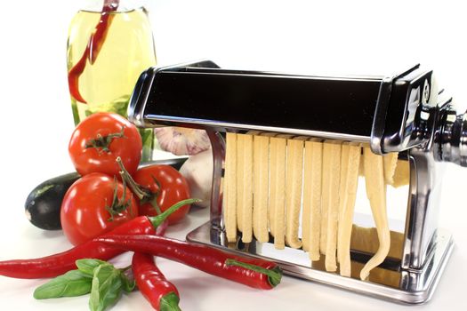 a pasta machine with homemade noodles