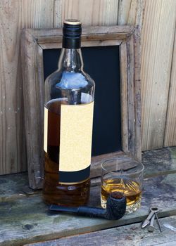 still life with bottle of whiskey and a glass