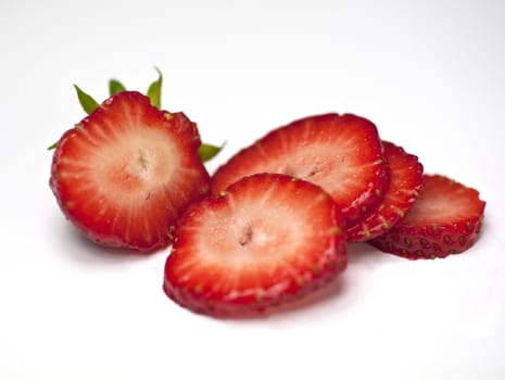 Closeup of a sliced single strawberry on a white background