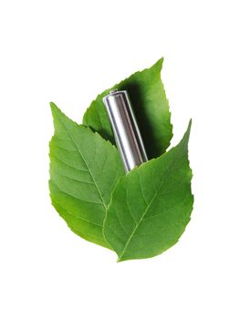 Ecology concept. Ordinary used battery lying on green leaves. Isolated on white with clipping path