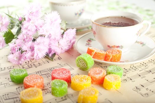 Candied fruit jelly with tea with flower