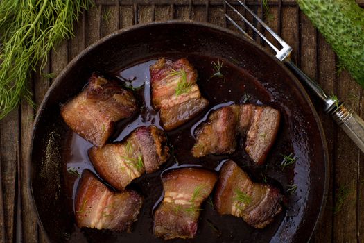 Roast meet with fat on the wooden table