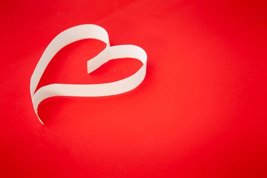 Paper heart on red background