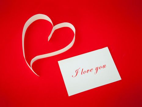 Paper heart on red background