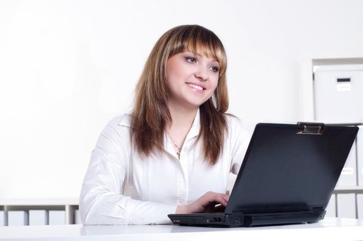 Young busines woman with notebook, in office
