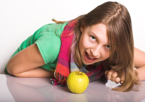 Teen attacks like a tiger an apple on the table