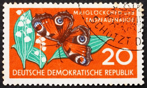 GDR - CIRCA 1959: a stamp printed in GDR shows Lily of the Valley and Butterfly, Nature, circa 1959
