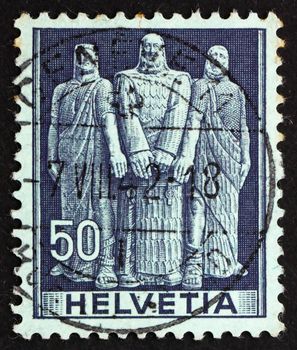 SWITZERLAND - CIRCA 1941: a stamp printed in the Switzerland shows The Three Swiss, Oath on Rutli Mountain, 1291, the Birth of the Old Swiss Confederacy, circa 1941