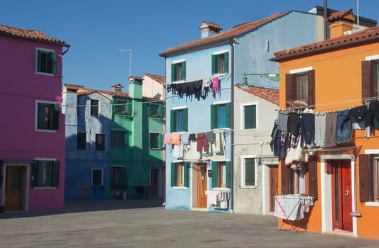 Brightly painted houses on the island of Burano, near Venice, on a sunny winter day