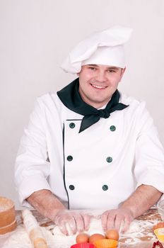 cook kneads the dough for cooking