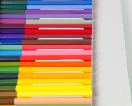 Color pencils in a box on white