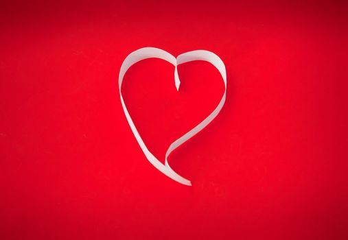 Paper heart on red background