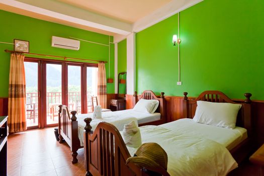 Hotel room in a tropical resort with bed