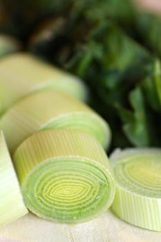 Closeup of a chopped leek on a wooden board in a kitchen